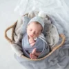 ニューボーンフォト_グレーの布に包まれたバスケットの中の新生児