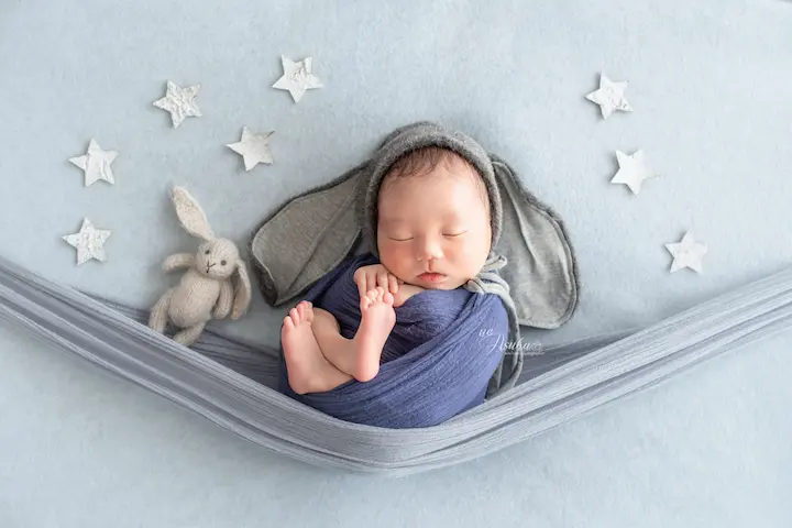 ニューボンフォト_星がちりばめられたハンモックで眠る新生児